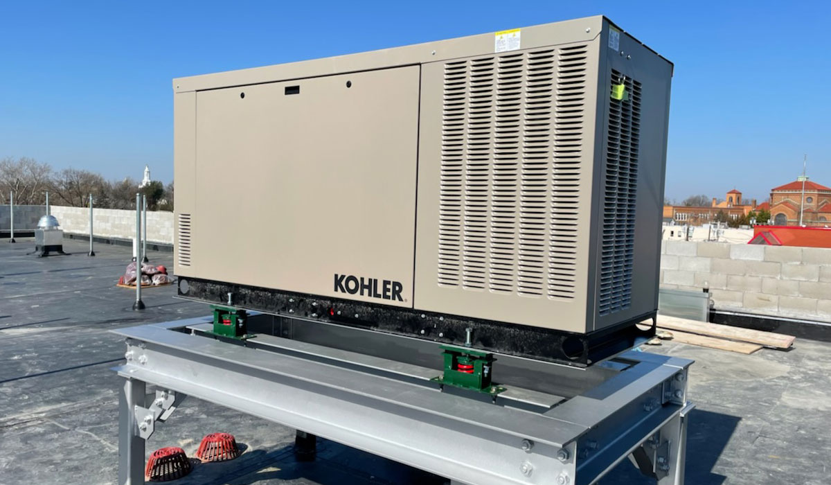 A large generator on top of a commercial rooftop.