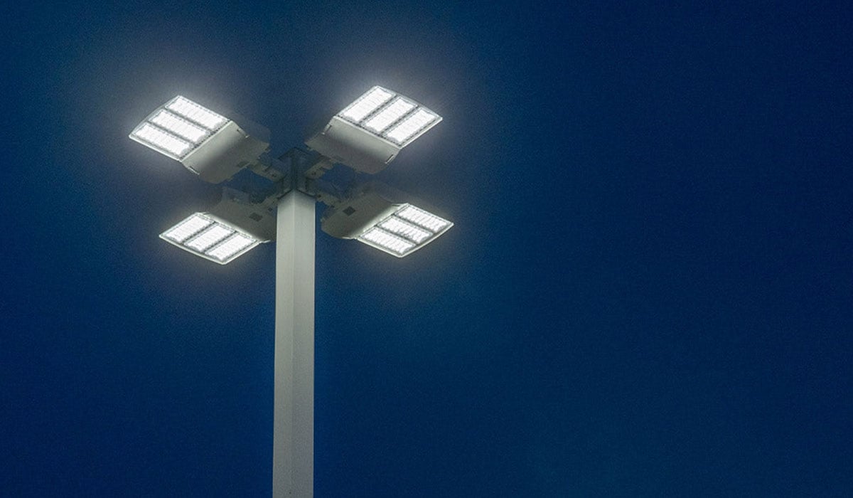 Commercial outdoor light post against a dark blue night sky.